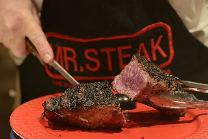 New York Strip cut down the middle, cooked medium rare and seasoned beautifully