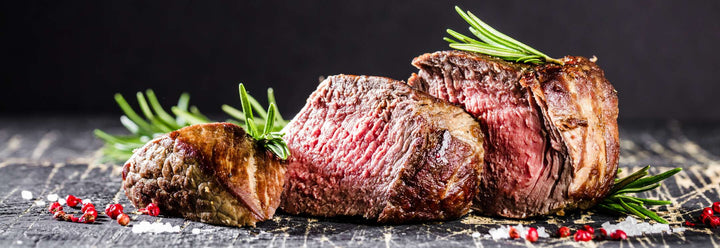 Perfectly cooked, medium rare beef tenderloin steaks with rosemary, pepper and salt