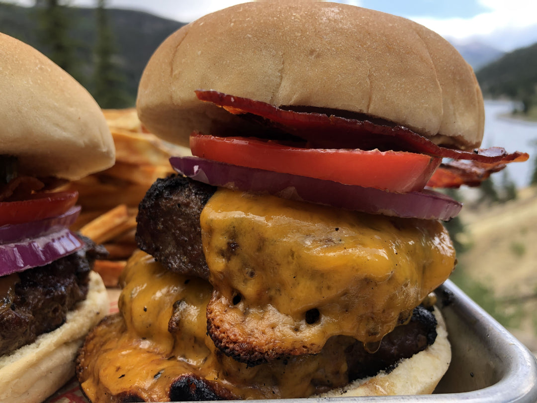 Juicy double cheeseburger with bacon, tomato and onion